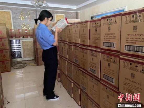 資料圖為檢察人員核對(duì)查獲的假冒品牌白酒。青海省人民檢察院供圖
