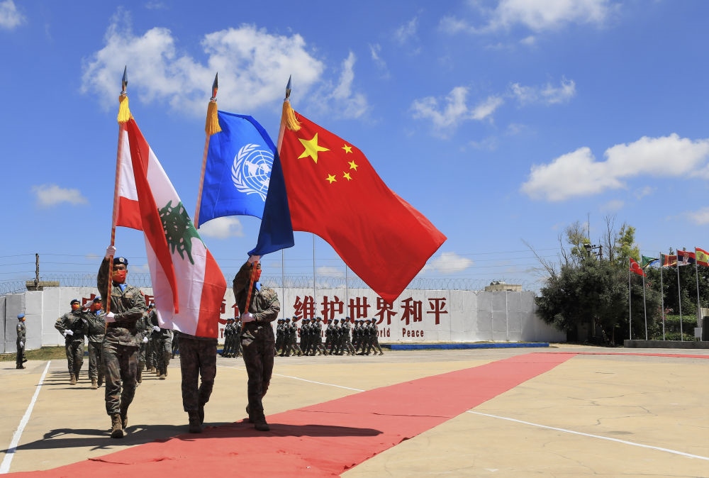 在黎巴嫩南部辛尼亞村的中國維和部隊營區(qū)，中國維和部隊官兵在受勛后通過觀禮臺（2022年7月1日攝）。聯(lián)合國駐黎巴嫩臨時部隊（聯(lián)黎部隊）當日授予中國第20批赴黎巴嫩維和部隊全體410名官兵聯(lián)合國“和平勛章”，以表彰他們?yōu)槔璋湍勰喜康貐^(qū)和平穩(wěn)定作出的突出貢獻。新華社記者 劉宗亞 攝