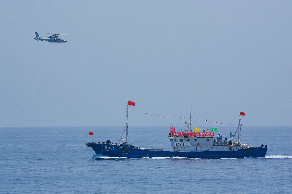 ↑中國海軍第40批護(hù)航編隊(duì)中的艦載直升機(jī)在被護(hù)船只周邊海域巡邏警戒（2022年6月4日攝）。新華社發(fā)（唐文 攝）