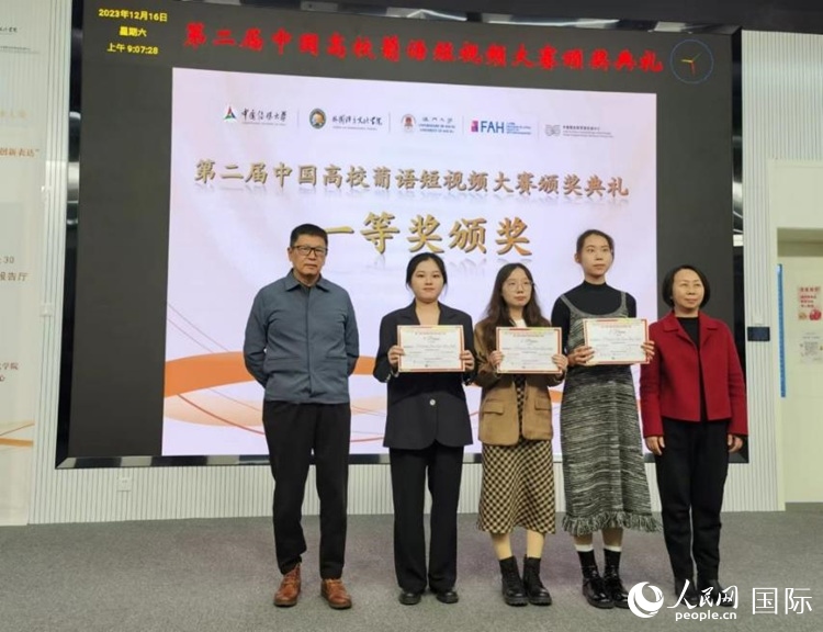 澳門大學(xué)中葡雙語教學(xué)暨培訓(xùn)中心主任姚京明（左一）和中國傳媒大學(xué)外國語言文化學(xué)院院長文春英（右一）為一等獎(jiǎng)獲得者頒獎(jiǎng)。人民網(wǎng)記者 魯揚(yáng)攝