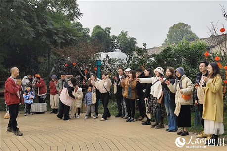 葉科（左一）給前來參與活動的“柑爸柑媽”介紹生態(tài)種植果。人民網(wǎng)記者朱虹攝