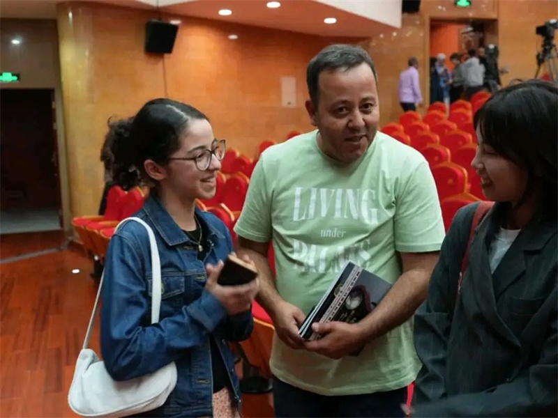 阿爾及利亞市民拉納·艾薩尼和她父親現(xiàn)場聆聽中阿交響樂演出 。蘇州交響樂團(tuán)供圖