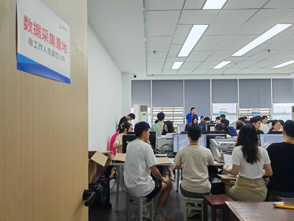 6月13日，在重慶市西南大學(xué)評卷點(diǎn)，工作人員正在進(jìn)行試卷掃描工作。新華社記者 周思宇 攝
