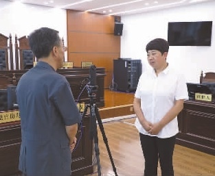 圖為全國人大代表玉明姬（右）詳細了解環(huán)境資源審判工作情況。劉思妤 攝