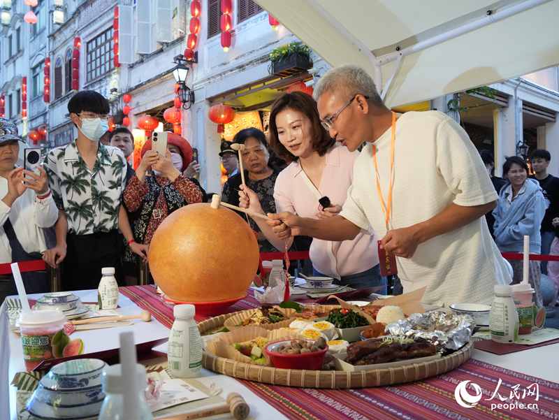 嘉賓品嘗海南傳統(tǒng)美食“煎堆”。人民網(wǎng)記者 張力洋攝